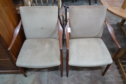 A pair of mid century teak upholstered elbow chairs, width 54cm, depth 63cm, height 84cm